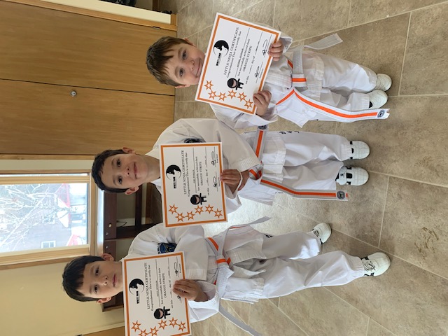 Kids holding Taekwon-Do certificates in King City