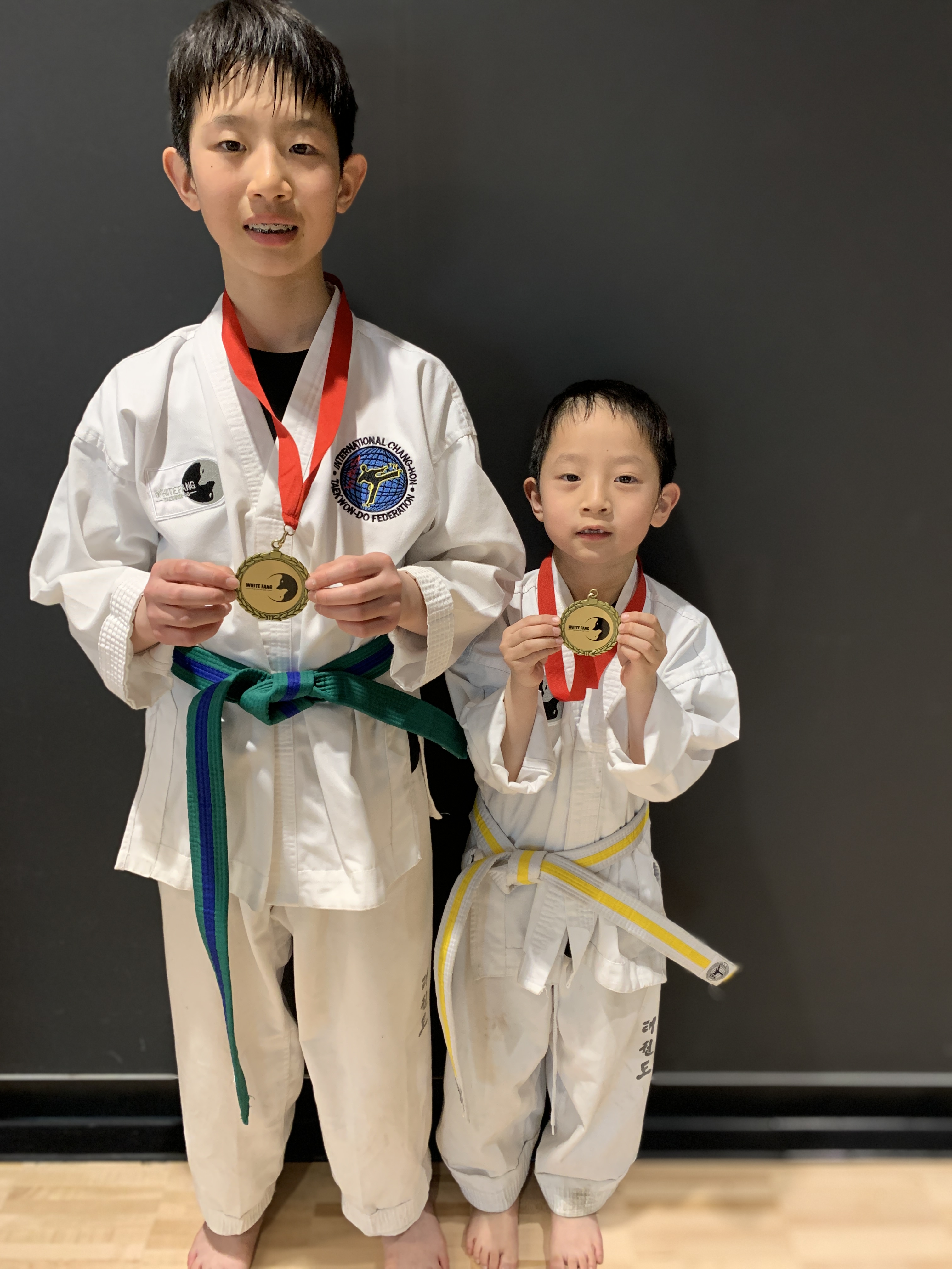 Kids showing medals after Taekwon-Do training