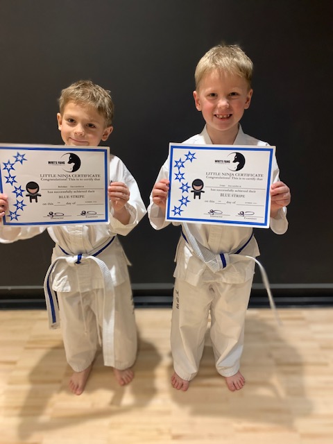 Kids martial arts students holding certificates in King City