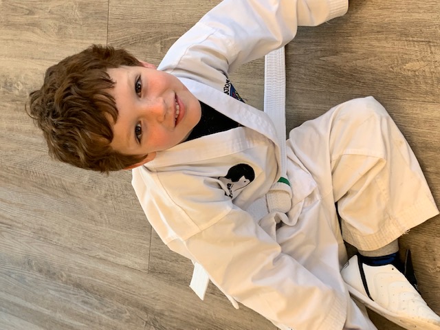 Young Taekwon-Do student wearing medals