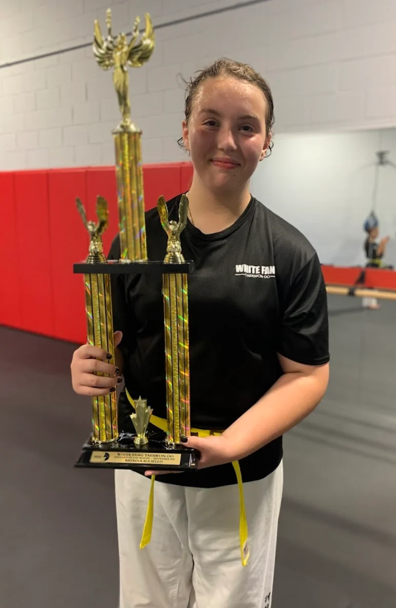 Woodbridge Taekwon-Do student Katrina holding her trophy