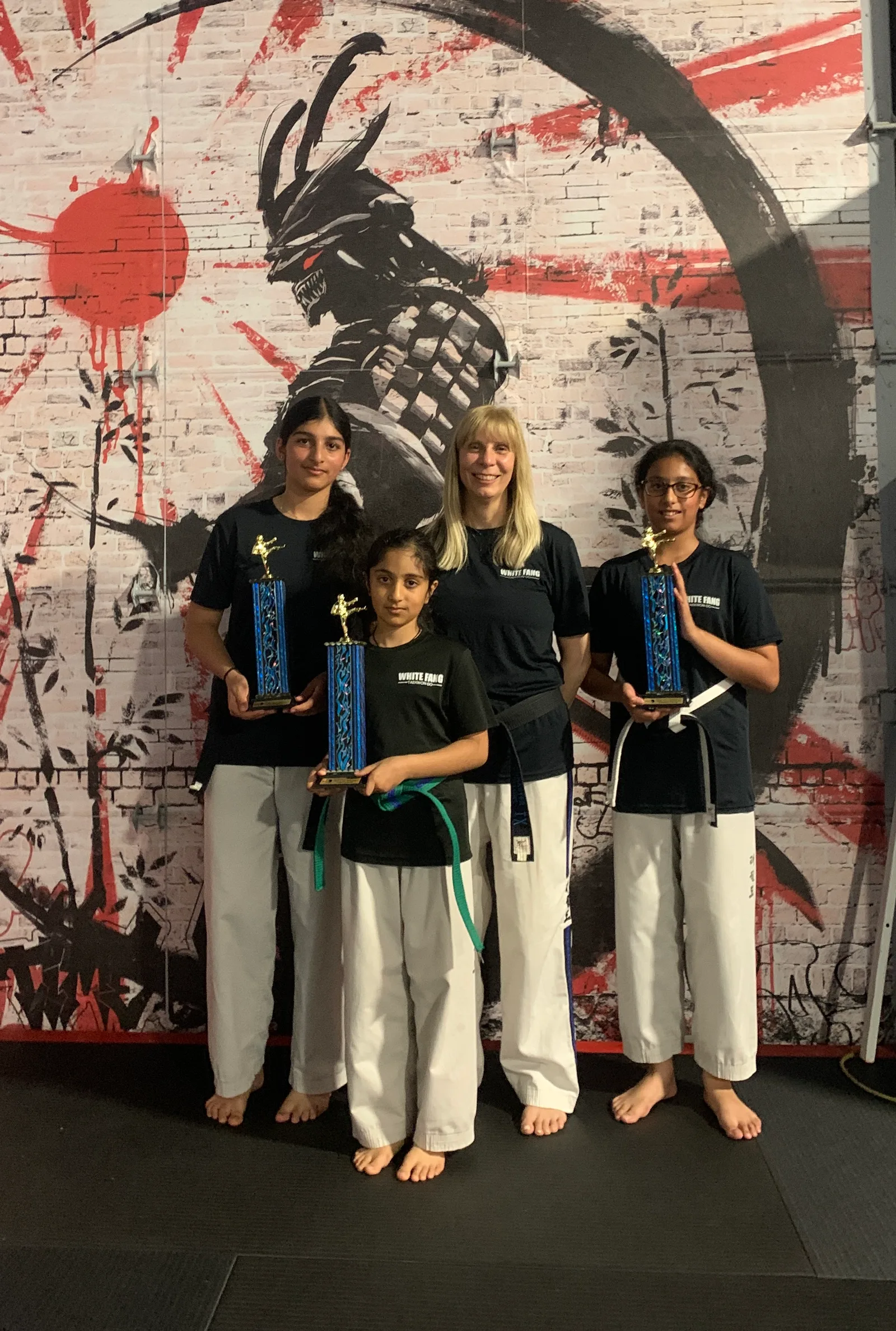 Kaler family students holding Taekwon-Do trophies in Woodbridge